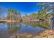 Tranquil pond view with reflection of trees and sky at 3228 Rosebud Rd, Loganville, GA 30052