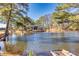Peaceful pond view with a home and mature trees at 3228 Rosebud Rd, Loganville, GA 30052