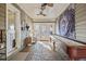 Enclosed sunroom with brick floor and shuffleboard table at 3228 Rosebud Rd, Loganville, GA 30052