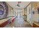 Charming sunroom with brick flooring and shuffleboard table at 3228 Rosebud Rd, Loganville, GA 30052