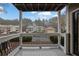 Balcony view of complex, parking lot, and wooded area at 411 Berkeley Woods Dr, Duluth, GA 30096
