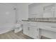 Bathroom features a granite countertop, white cabinets, and shower-tub combination at 411 Berkeley Woods Dr, Duluth, GA 30096