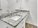 Bathroom featuring granite countertop, modern faucet, and white cabinets at 411 Berkeley Woods Dr, Duluth, GA 30096