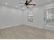 Bright bedroom features light wood floors, ceiling fan, and access to the backyard at 411 Berkeley Woods Dr, Duluth, GA 30096