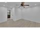 This empty room has wood floor, a ceiling fan, and a view to the ensuite bathroom at 411 Berkeley Woods Dr, Duluth, GA 30096