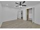 Spacious bedroom with fan, closet, and light-colored flooring at 411 Berkeley Woods Dr, Duluth, GA 30096