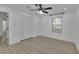 Bright bedroom features light wood floors, ceiling fan, and double-door closet at 411 Berkeley Woods Dr, Duluth, GA 30096