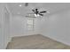 Bright bedroom features light wood floors, ceiling fan, and double-door closet at 411 Berkeley Woods Dr, Duluth, GA 30096