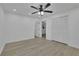 Clean bedroom with fan, light-colored flooring, and closet at 411 Berkeley Woods Dr, Duluth, GA 30096