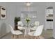 Staged dining room featuring new floors, a modern chandelier, and kitchen views at 411 Berkeley Woods Dr, Duluth, GA 30096
