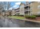 Exterior view showcasing the building's design with balconies, windows, and well-maintained landscaping at 411 Berkeley Woods Dr, Duluth, GA 30096