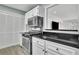 Updated kitchen with stainless steel appliances and black countertop at 411 Berkeley Woods Dr, Duluth, GA 30096