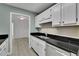 Modern kitchen with stainless steel appliances and a view into another room at 411 Berkeley Woods Dr, Duluth, GA 30096