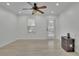 Bright living room with light wood floors, ceiling fan, and plenty of natural light at 411 Berkeley Woods Dr, Duluth, GA 30096
