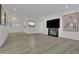 Large living room featuring new floors, a fireplace, and pass-through to the kitchen at 411 Berkeley Woods Dr, Duluth, GA 30096