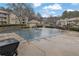 Community pool with covered pool with nearby apartment buildings at 411 Berkeley Woods Dr, Duluth, GA 30096