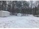 Two sheds in snowy backyard with wooded backdrop at 1485 Reynolds Sw Rd, Atlanta, GA 30331