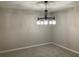 Dining room with new carpet, paint, and modern chandelier at 1485 Reynolds Sw Rd, Atlanta, GA 30331