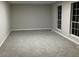 Large living room with gray carpet and big windows at 1485 Reynolds Sw Rd, Atlanta, GA 30331