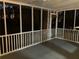 Screened porch with ceiling fan and wooded view at 1485 Reynolds Sw Rd, Atlanta, GA 30331