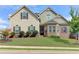 Two-story house with beige siding, brick accents, and a well-manicured lawn at 45 Silver Peak Dr, Covington, GA 30016