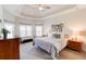 Main bedroom with tray ceiling, window seat, and carpeted floor at 45 Silver Peak Dr, Covington, GA 30016