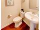 Powder room with pedestal sink and hardwood floors at 45 Silver Peak Dr, Covington, GA 30016