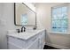 Bathroom featuring a dual sink vanity with marble countertop, black fixtures, and an oversized mirror at 59 Stafford Nw St, Atlanta, GA 30314