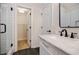 Bright bathroom featuring a marble vanity top, white subway tile, black fixtures, and a walk-in closet at 59 Stafford Nw St, Atlanta, GA 30314