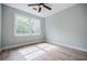 Bright bedroom with a ceiling fan, large window with natural light, and beautiful light colored laminate floors at 59 Stafford Nw St, Atlanta, GA 30314