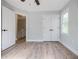 Light-filled bedroom featuring modern ceiling fan, wood laminate flooring, and a double door closet for storage at 59 Stafford Nw St, Atlanta, GA 30314