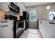 This modern kitchen features black stainless appliances, white cabinets and gorgeous countertops at 59 Stafford Nw St, Atlanta, GA 30314