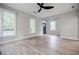 Bright living room featuring hardwood floors, ceiling fan, and multiple windows at 59 Stafford Nw St, Atlanta, GA 30314