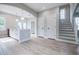 Open-concept living area boasts wood floors, access to the staircase, and arched doorway at 59 Stafford Nw St, Atlanta, GA 30314