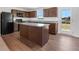 Kitchen island with granite countertops and dark brown cabinets at , Stone Mountain, GA 30087