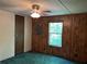 Bedroom featuring paneled walls, a ceiling fan and olive colored carpet at 218 Helen Rd, Covington, GA 30016