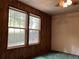 Bedroom with two windows and wood paneled walls at 218 Helen Rd, Covington, GA 30016