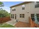 Exterior view of the home features a patio and wood fence, with lush trees surrounding the property at 2396 Whiteoak Se Bnd # 16, Smyrna, GA 30080