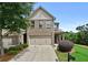 Charming two-story home featuring a brick facade, two-car garage, and a well-maintained landscaped front yard at 2396 Whiteoak Se Bnd # 16, Smyrna, GA 30080