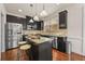 Modern kitchen showcasing a center island with seating, stainless appliances, and dark cabinets at 2396 Whiteoak Se Bnd # 16, Smyrna, GA 30080
