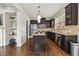 Modern kitchen featuring dark cabinetry, stainless steel appliances, granite countertops and a functional island at 2396 Whiteoak Se Bnd # 16, Smyrna, GA 30080