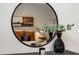 Close-up view of bedroom decor, featuring a round mirror and plants at 400 Village Ne Pkwy # 120, Atlanta, GA 30306