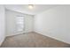 Well-lit bedroom with neutral walls and carpet flooring at 5547 Strathmoor Manor Cir, Lithonia, GA 30058