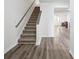 Staircase and wood-look flooring in the entryway at 5547 Strathmoor Manor Cir, Lithonia, GA 30058