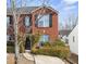 Brick townhouse with black shutters and a landscaped front yard at 5547 Strathmoor Manor Cir, Lithonia, GA 30058