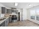 Modern kitchen with gray cabinets and stainless steel appliances at 5547 Strathmoor Manor Cir, Lithonia, GA 30058