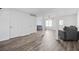 Open living room with gray sofas and wood-look flooring at 5547 Strathmoor Manor Cir, Lithonia, GA 30058