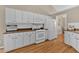 Modern kitchen with white cabinets, brown countertops, and stainless steel appliances at 1395 Heatherton Rd, Dacula, GA 30019