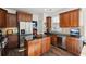 Modern kitchen with stainless steel appliances and dark wood cabinets at 2175 Creole Cir, Cumming, GA 30040