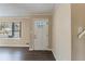 Front entry with white door and dark laminate floors at 2473 Tyler Way, Decatur, GA 30032